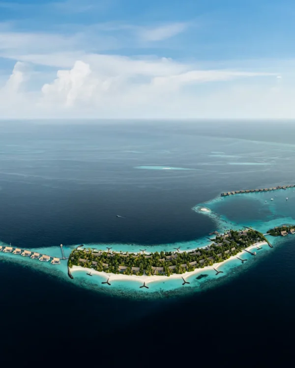 Aerial view of Waldorf Astoria Maldives Ithaafushi with overwater villas and turquoise lagoon