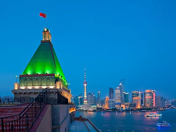 Fairmont Peace Hotel rooftop overlooking the Bund and Pudong skyline in Shanghai, China