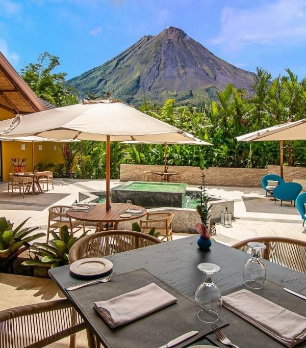 Outdoor dining terrace with Arenal Volcano views at Nayara Gardens in Costa Rica