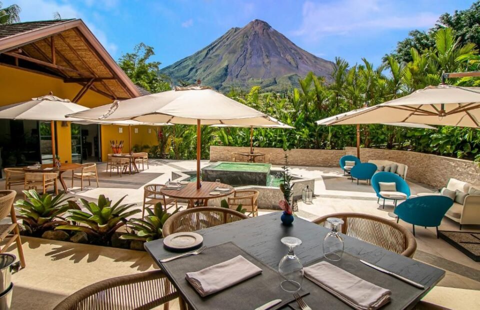 Outdoor dining terrace with Arenal Volcano views at Nayara Gardens in Costa Rica