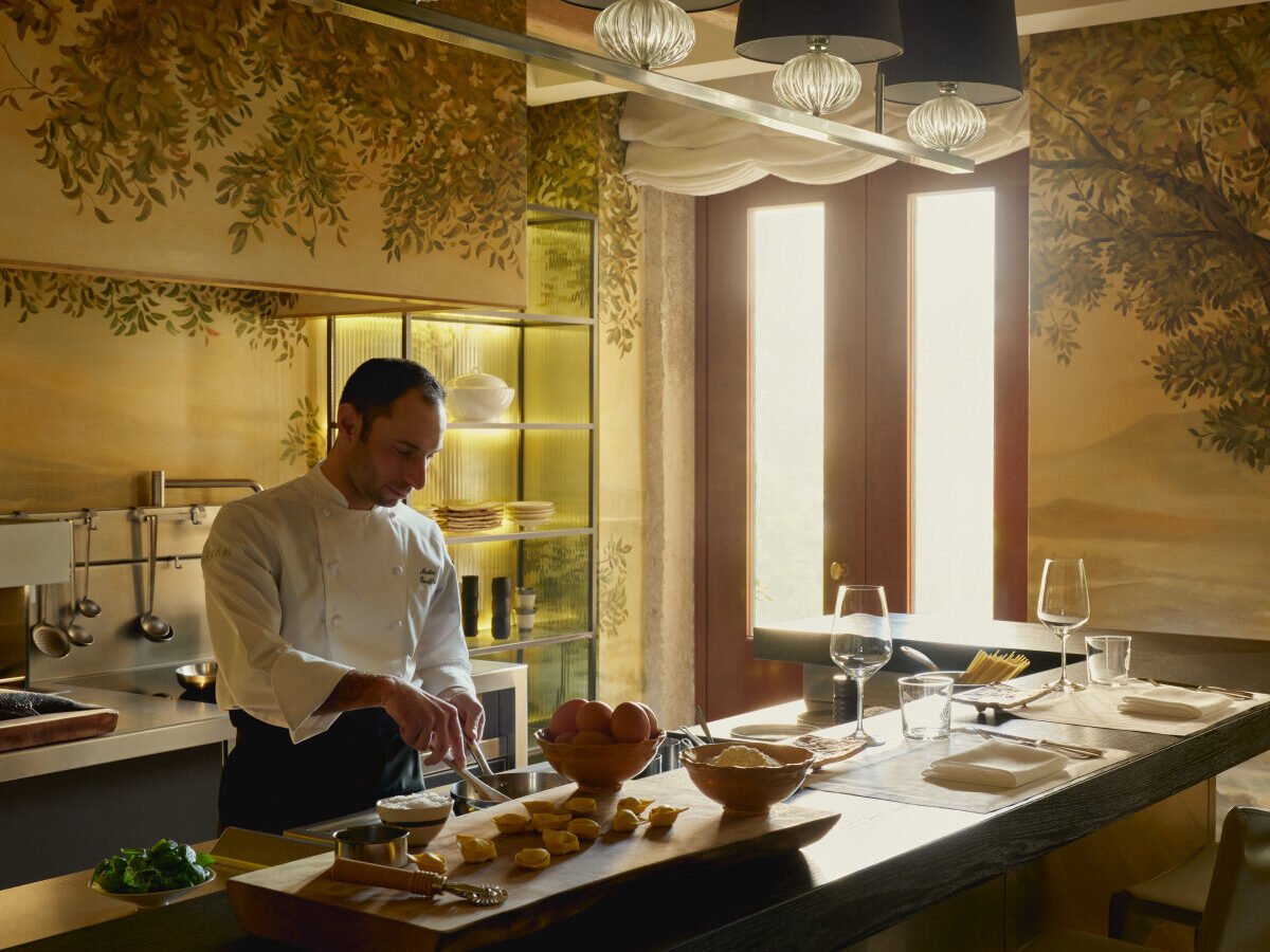 Chef preparing fresh Italian cuisine in the Palazzo Kitchen at Aman Venice luxury hotel