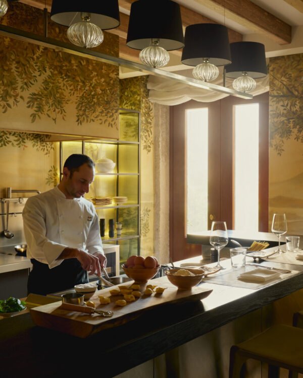 Chef preparing fresh Italian cuisine in the Palazzo Kitchen at Aman Venice luxury hotel