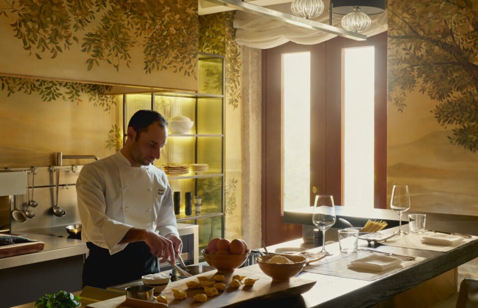 Chef preparing fresh Italian cuisine in the Palazzo Kitchen at Aman Venice luxury hotel