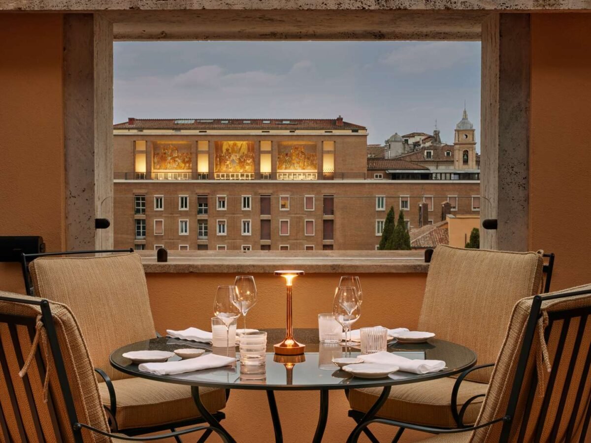 Rooftop terrace dining at Bulgari Hotel Roma overlooking the historic Rome skyline