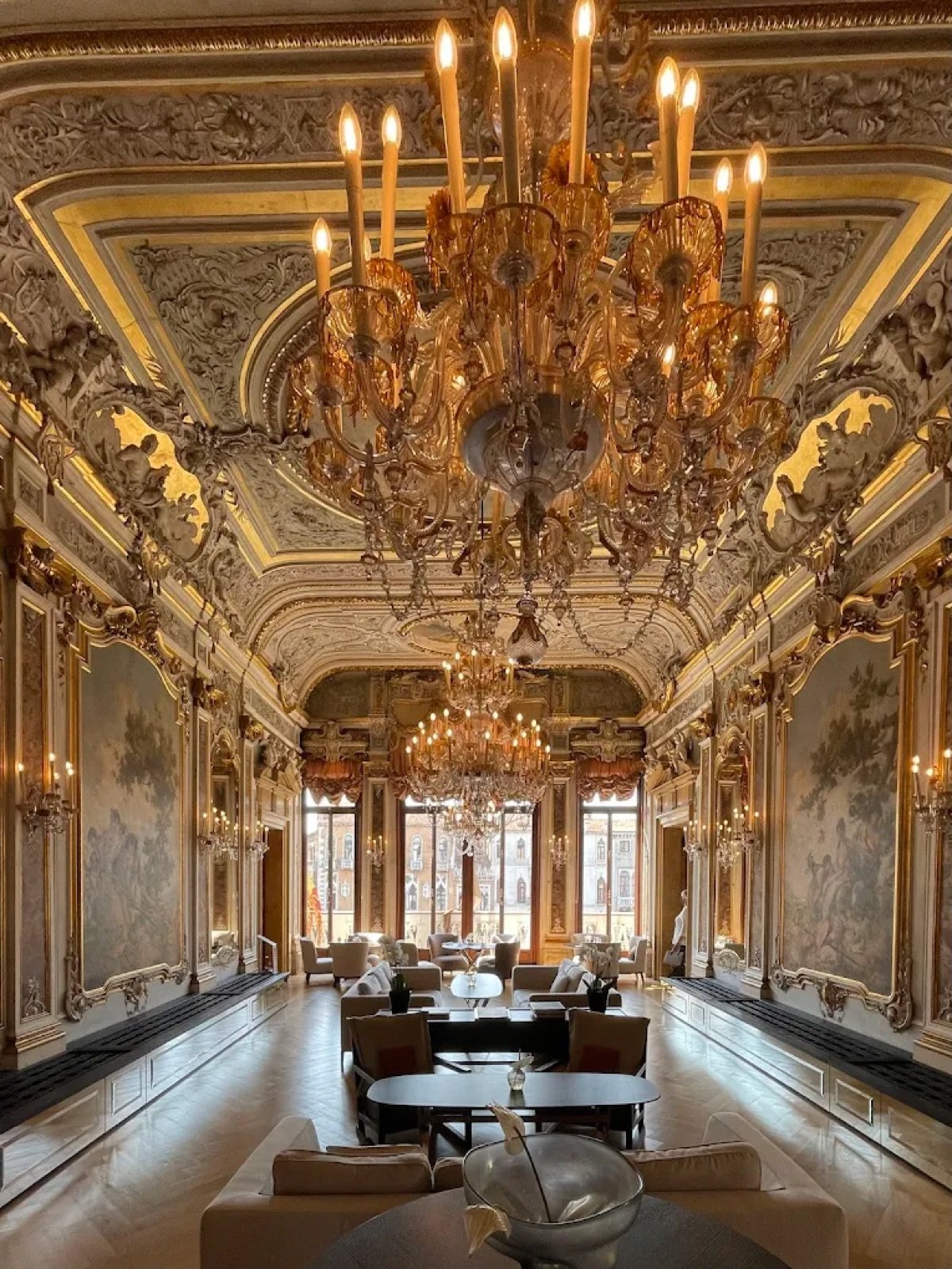 Frescoed grand salon with chandeliers and lounge seating