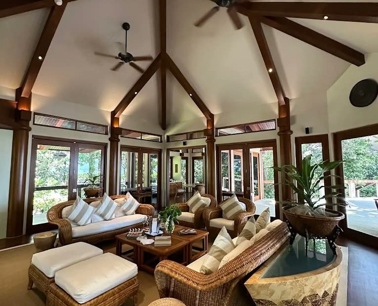 Vaulted villa living pavilion with rattan seating and garden light