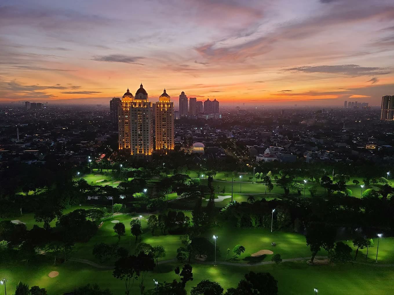 Sunset over the Senayan golf course and city towers from Fairmont Jakarta