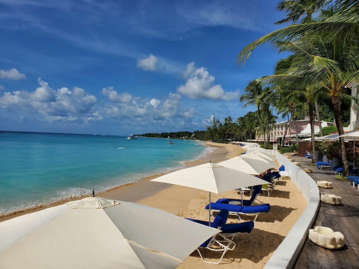 White parasols and loungers on the beach at Fairmont Royal Pavilion, Barbados