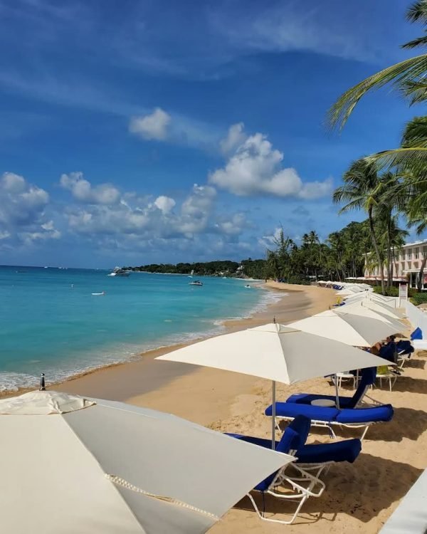 White parasols and loungers on the beach at Fairmont Royal Pavilion, Barbados