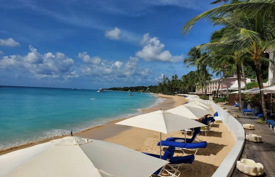 White parasols and loungers on the beach at Fairmont Royal Pavilion, Barbados