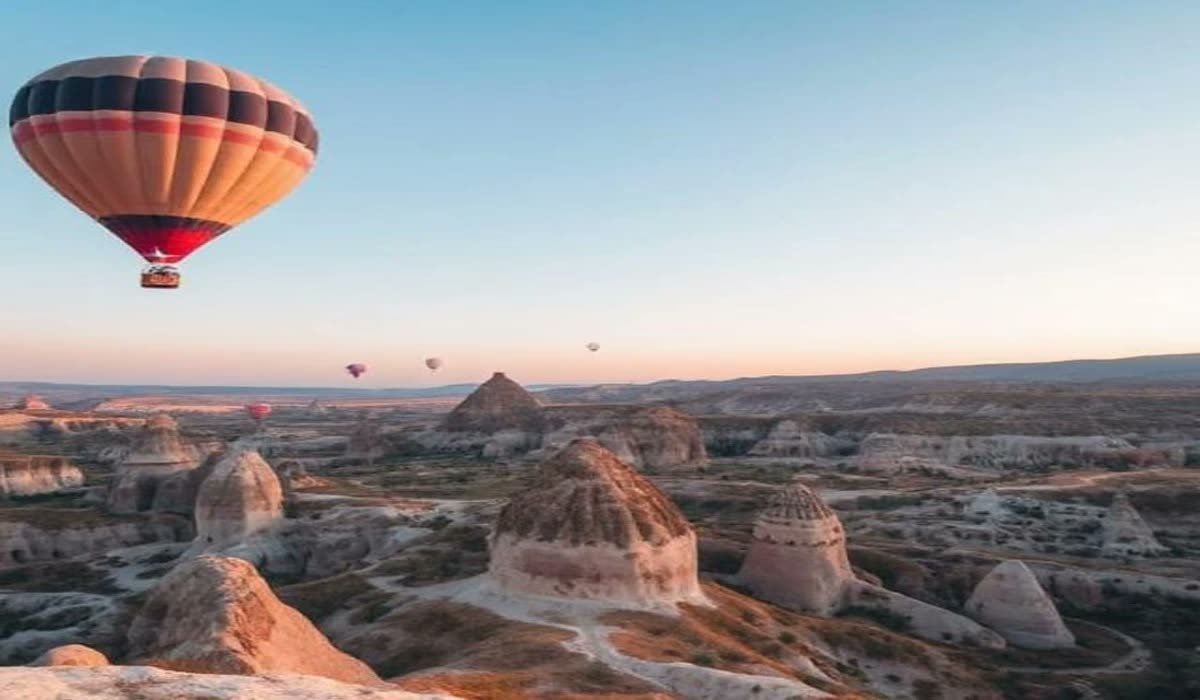 Hot air balloons above the fairy chimney valleys of Cappadocia at dawn