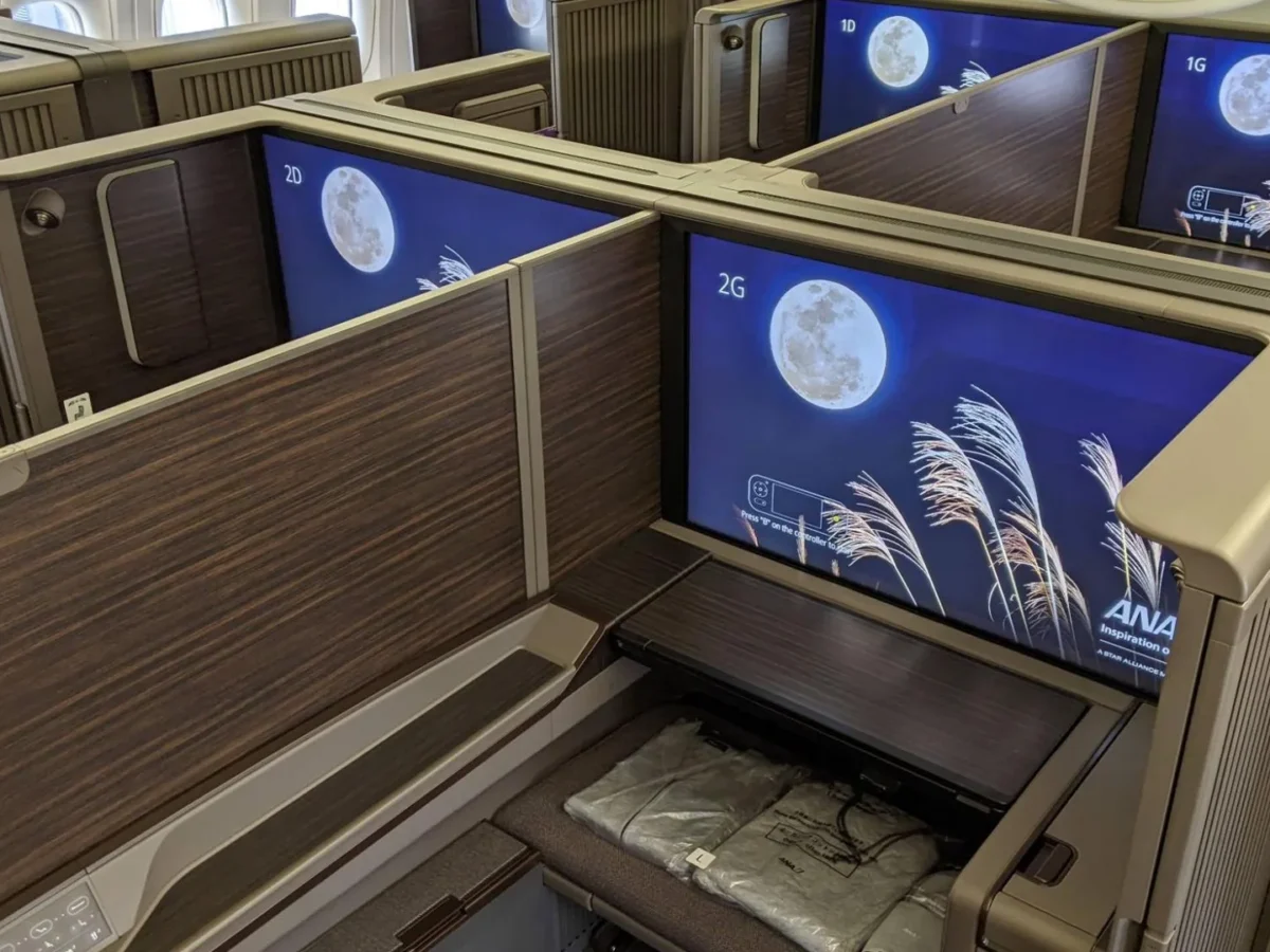 ANA First Class Suite cabin with private enclosed seats and large entertainment screens