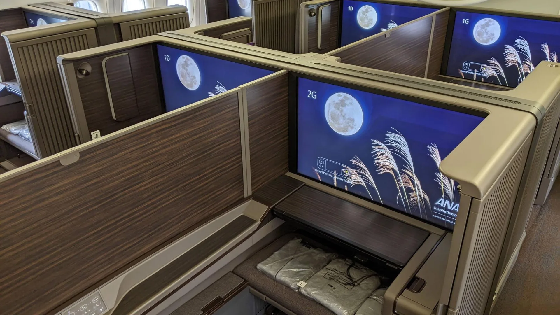 ANA First Class Suite cabin with private enclosed seats and large entertainment screens