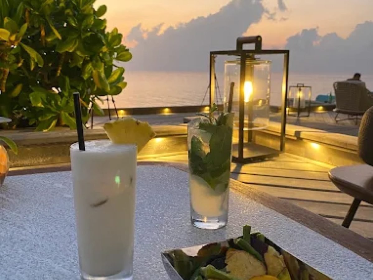 Cocktails on a resort deck at sunset in the Maldives