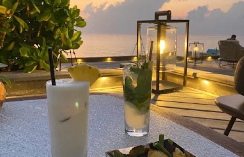 Cocktails on a resort deck at sunset in the Maldives