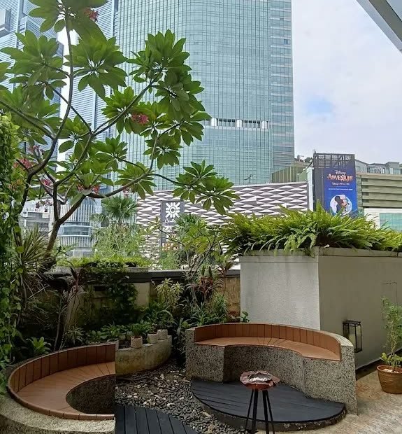 Planted terrace seating beneath the towers at Mandarin Oriental Jakarta