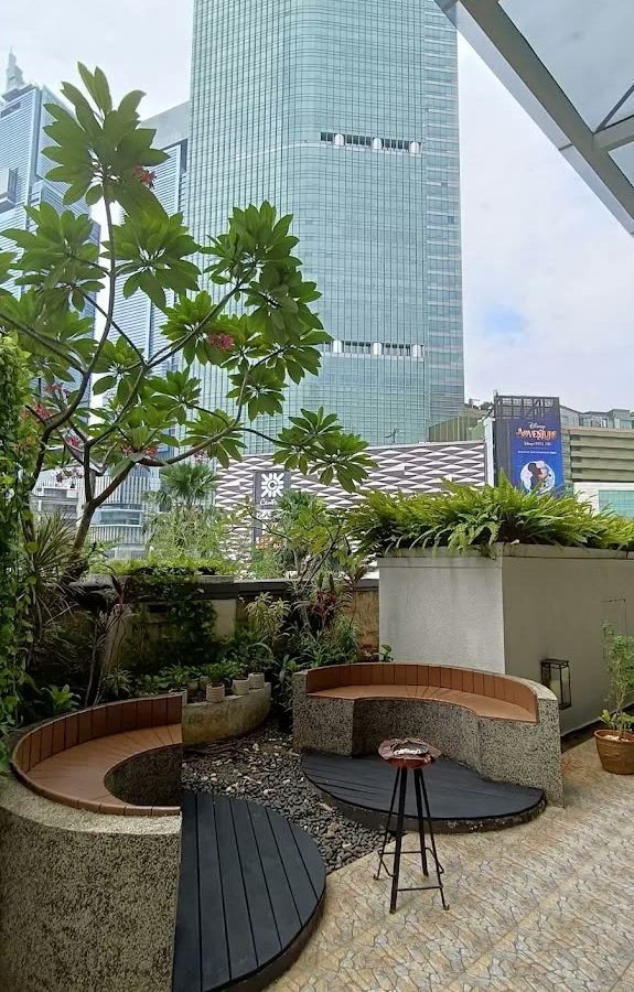 Planted terrace seating beneath the towers at Mandarin Oriental Jakarta