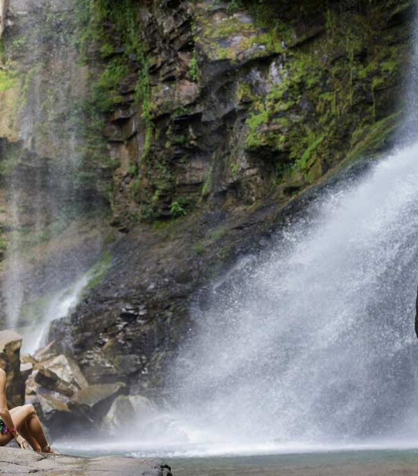 Guest enjoying a waterfall experience near Kura Costa Rica in the lush rainforest