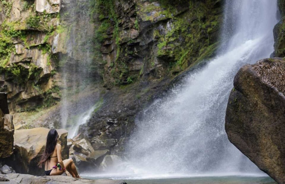 Guest enjoying a waterfall experience near Kura Costa Rica in the lush rainforest