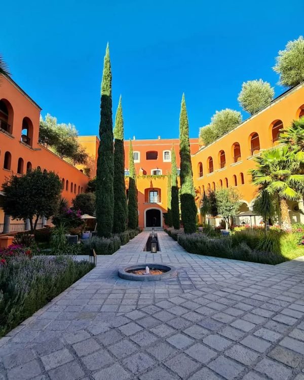 Arched courtyard with cypresses, lavender beds and a stone fountain