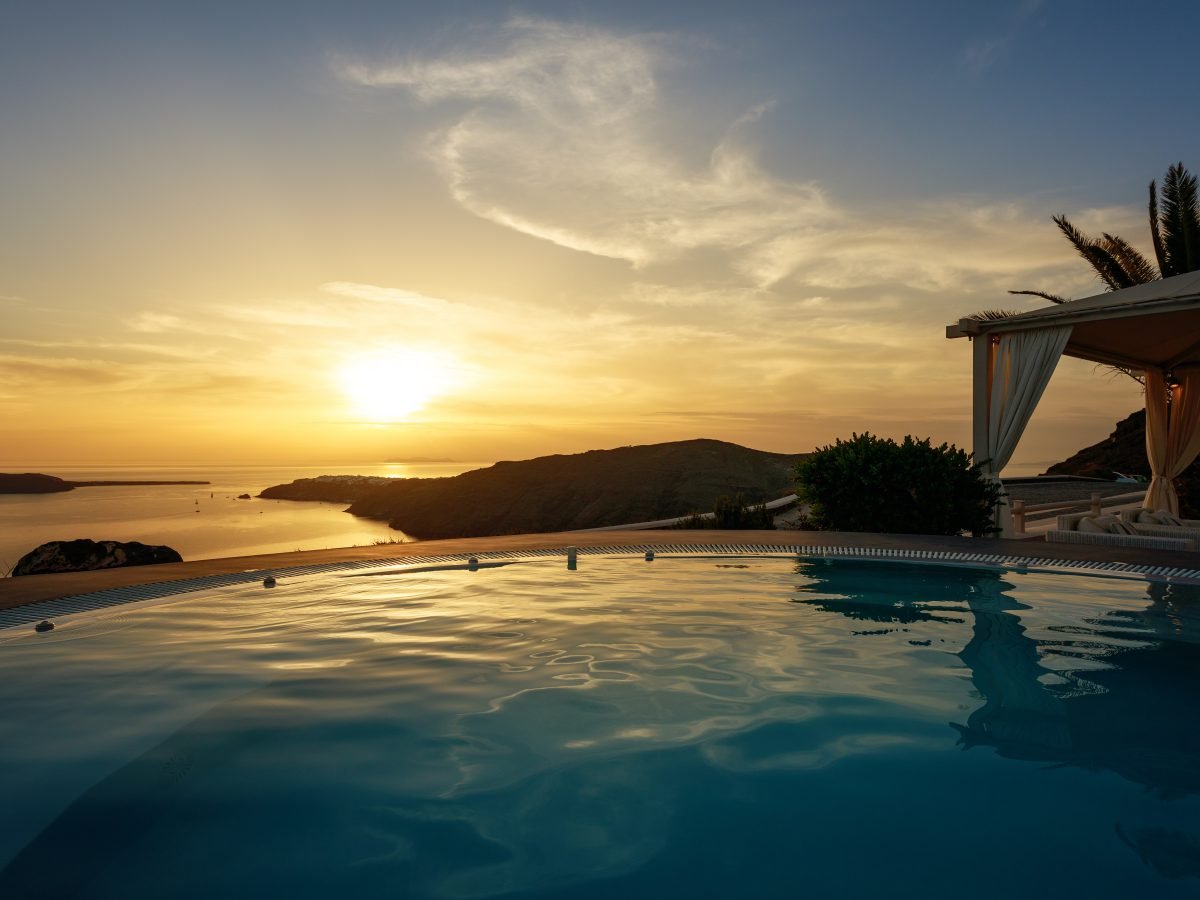 Cliffside infinity pool overlooking the sea at dusk