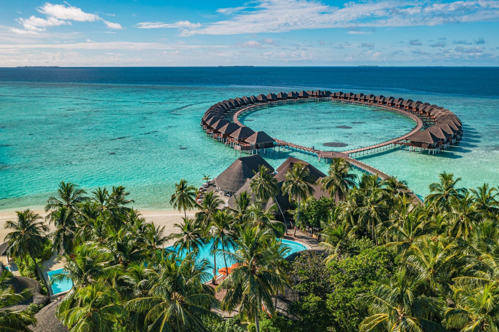Aerial view of Maldives overwater villas and palm island