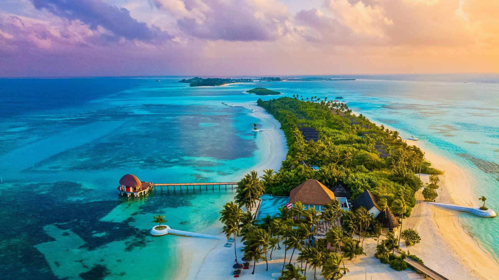 Aerial view of a Maldives atoll island at sunset