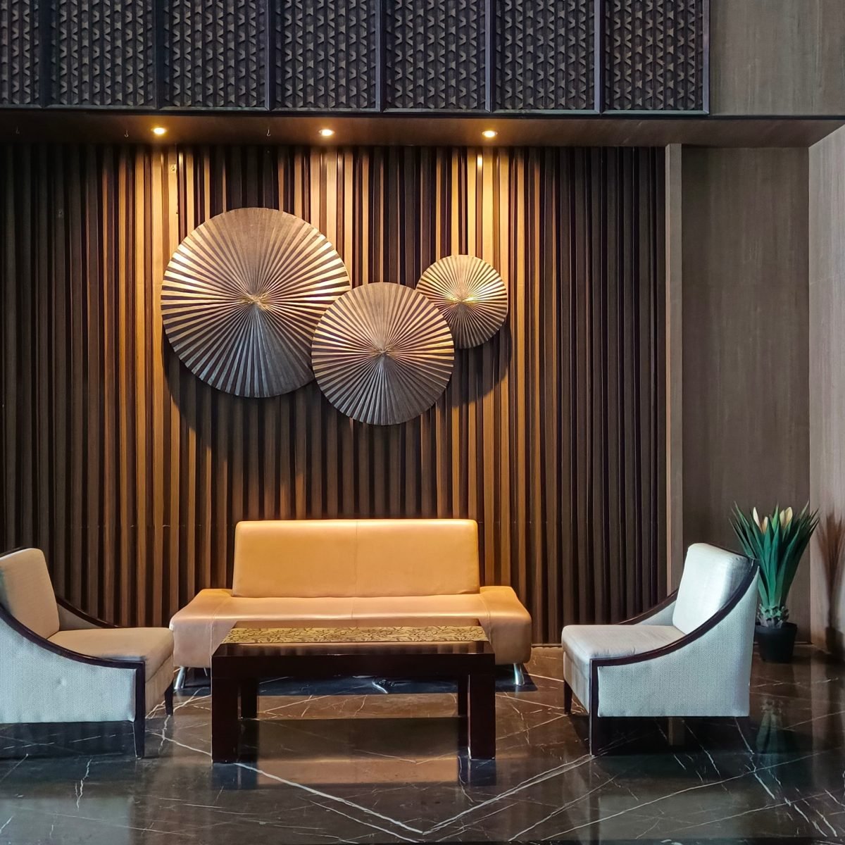 Dark, gold-detailed hotel lounge lit for the evening