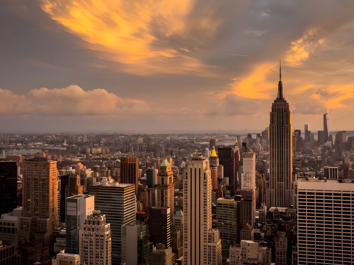 Empire State Building under golden-hour clouds over Manhattan