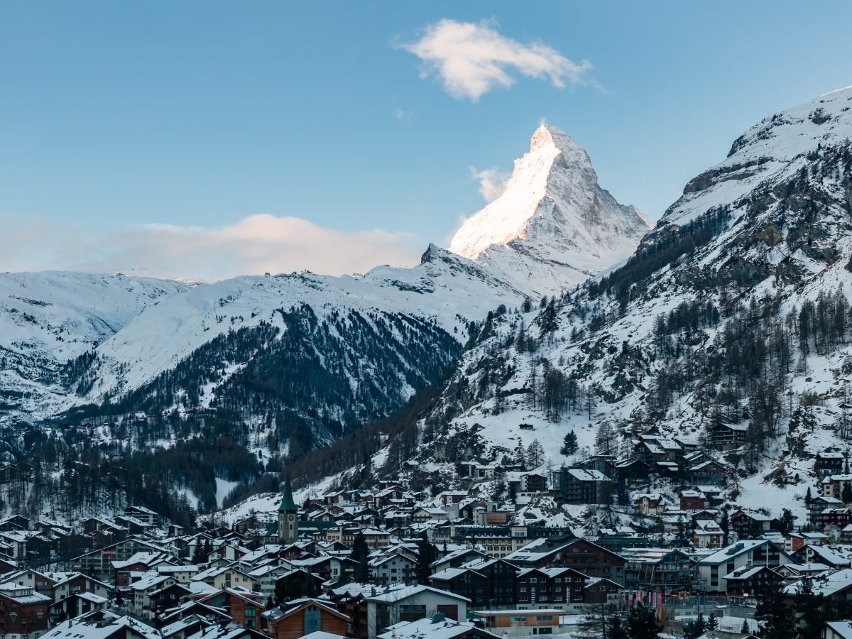 The Matterhorn rising above snow-covered Zermatt rooftops