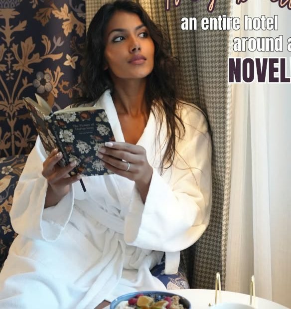 Guest in a robe reading in a suite at The Dorian, Calgary