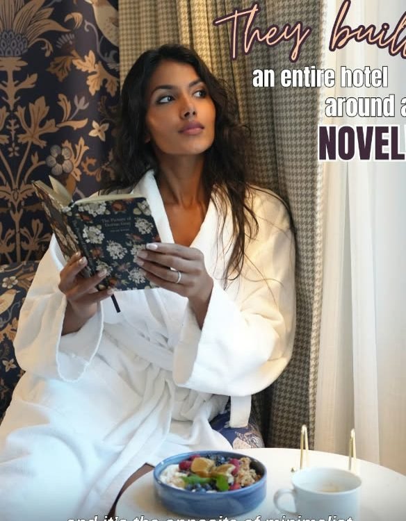 Guest in a robe reading in a suite at The Dorian, Calgary