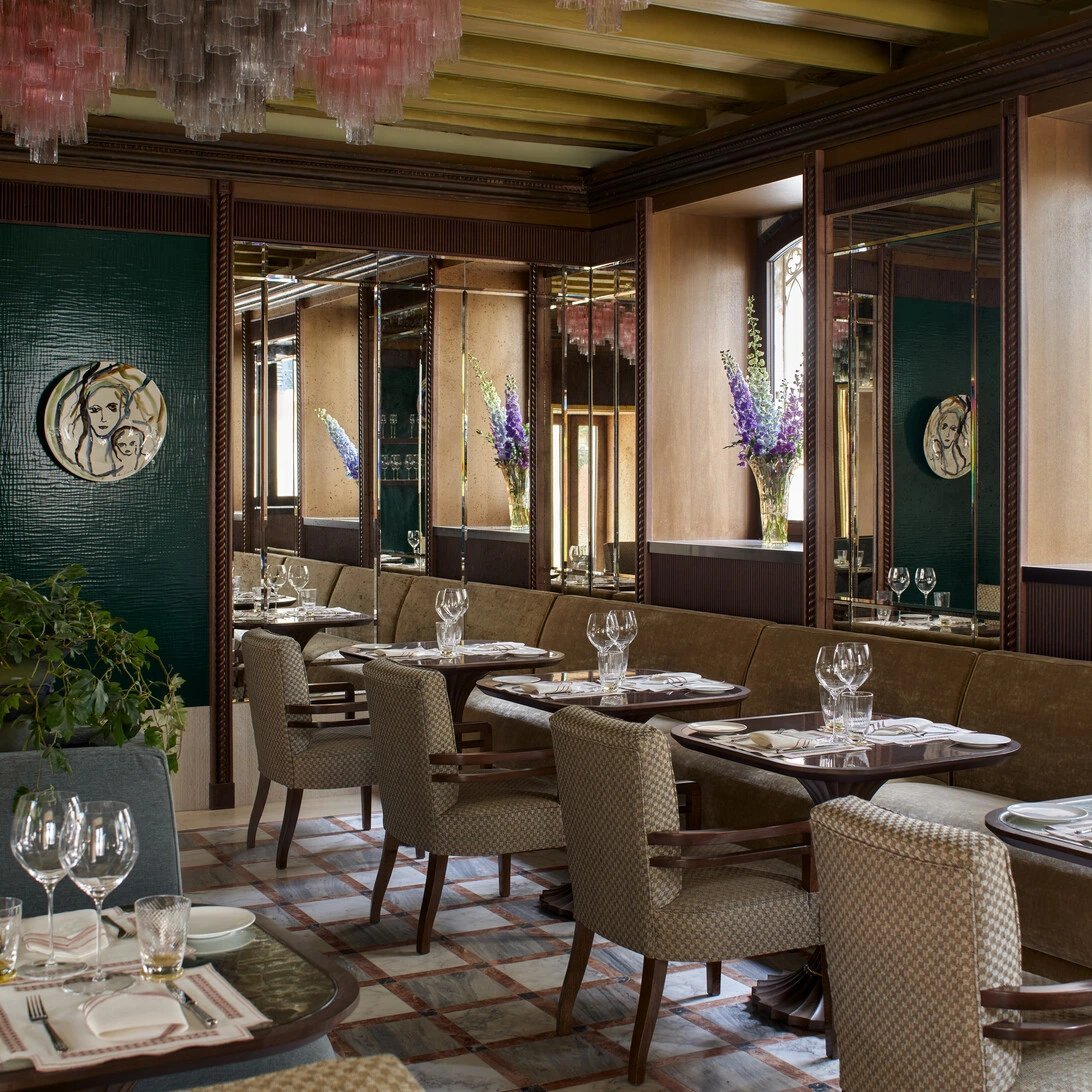 La Casati restaurant at Orient Express Venezia with velvet seating, patterned walls and tables set beside garden windows