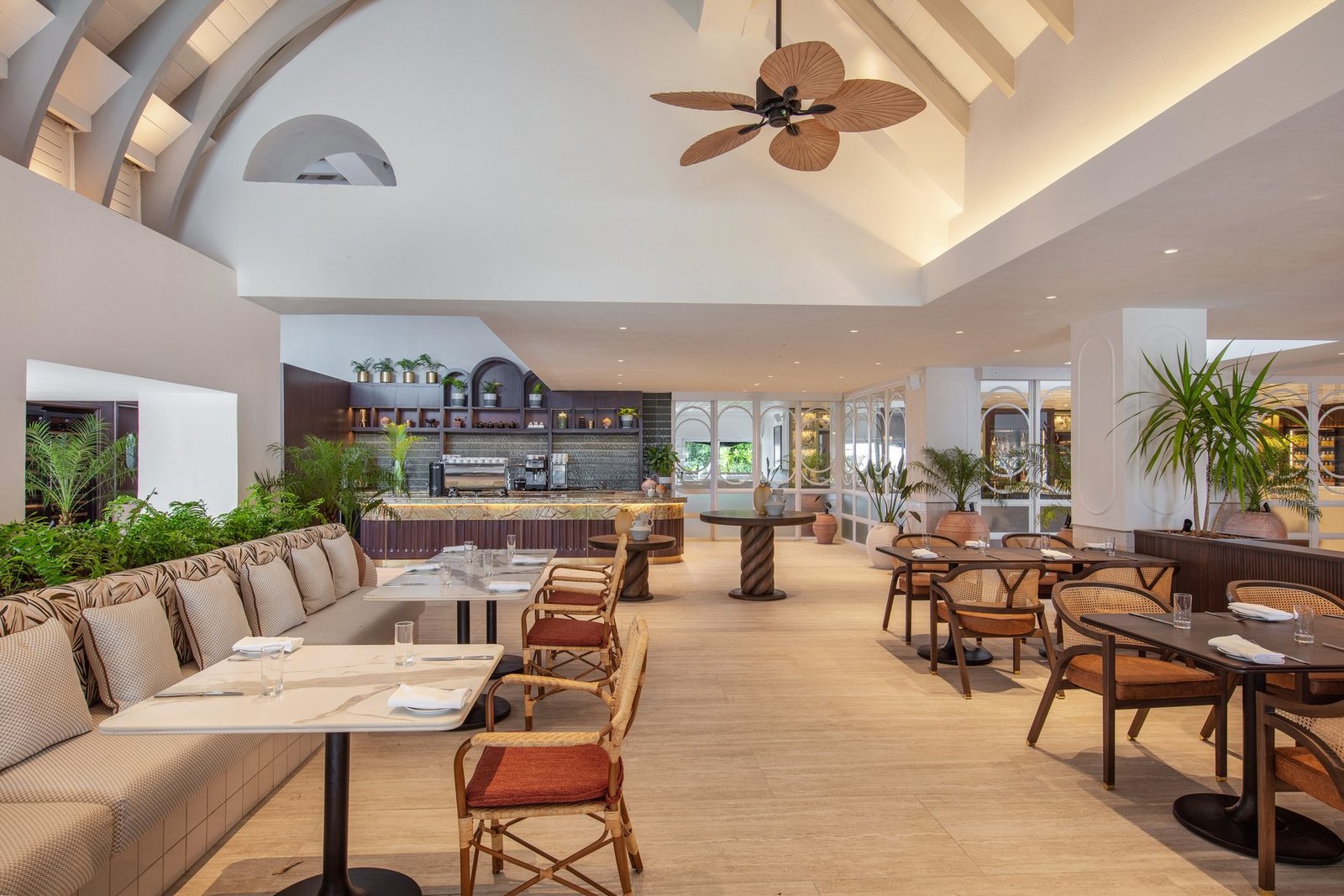 Redesigned beachside restaurant at Shangri-La Le Touessrok with rattan chairs, light wood tables and views of the lagoon