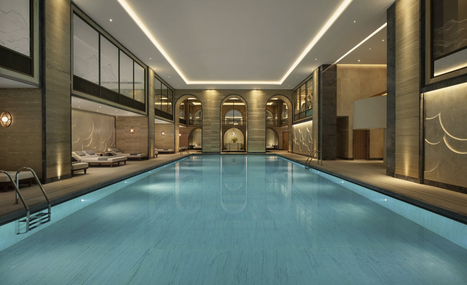 Indoor swimming pool with vaulted ceiling and loungers at the Guerlain Spa, Raffles London at The OWO