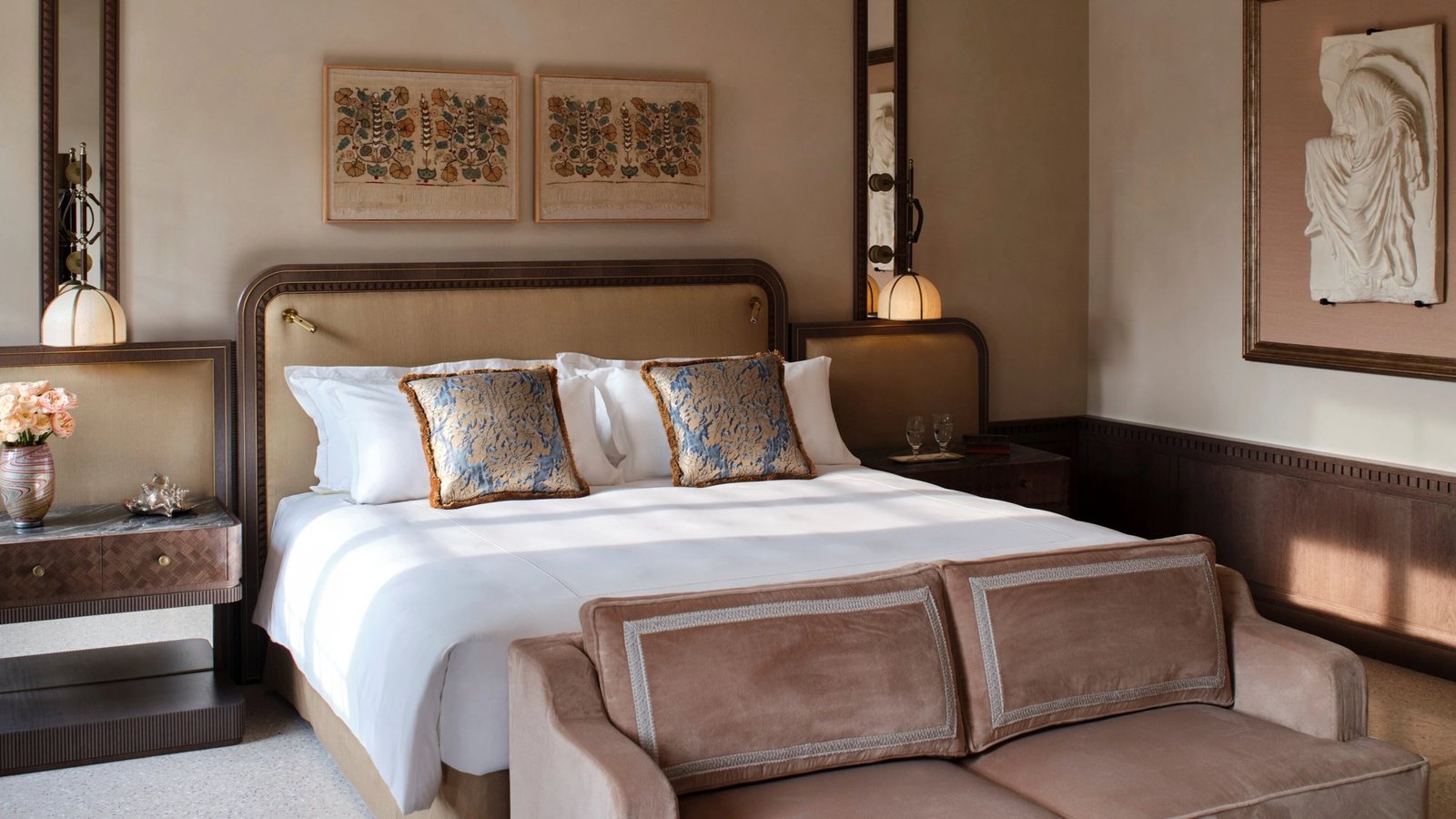Guest room at Orient Express Venezia with hand-painted Venetian panels, Murano glass lighting and a canopy-style bed